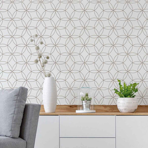 A simple design that celebrates the magic of geometry, this peel and stick wallpaper features a seamless, structured arrangement of intersecting circles. The circles are outlined in black on a white background. Their scale and minimal line weights give this wallpaper a polished sophistication that can easily blend with classic or Art Deco settings, while at the same time remaining perfectly compatible with informal contemporary spaces.