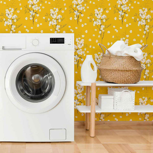 Transform any space into an autumnal paradise with this stunning floral wallpaper that combines gentle white blossoms with an intense mustard yellow background. The small-scale botanical illustrations in this design are simple and almost motif-like, balancing the dramatic yellow hue with a mild whimsical vibe. Try this PVC-free wallpaper to completely transform your bathrooms and utility spaces.