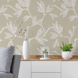 Serving subtle sophistication in serene grey tones, this botanical peel and stick wallpaper turns your walls into a work of art. Branches and leaves meander across the wallpaper panels as white sketches on a warm taupe background. They create a composition that is organic and free, yet structured into a basic geometrical pattern.