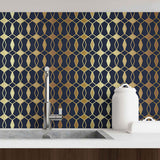 Care for some regal splendor in your standard apartment? This gorgeous geometric wallpaper with an Art Deco vibe will upgrade the ambiance instantly. Its deep blue background showcases a beautiful trellis printed with varying yellow and beige notes to produce a golden look. The metallic effect of this peel and stick wallpaper makes it perfect for styling up a living room or an expansive kitchen.
