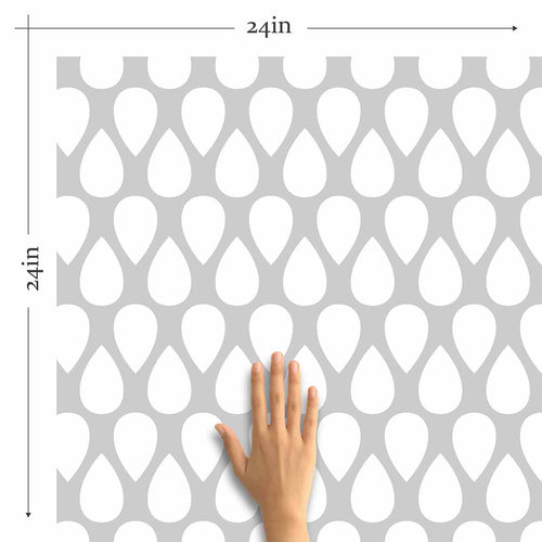 An elegant trellis takes on a fun, new-age vibe in this unique geometric wallpaper. The teardrop shaped motifs in this grey and white peel and stick wallpaper are arranged in neat rows facing alternate directions to create a charming lattice that brings an informal yet structured feel to your living space. This versatile design will bring time-tested elegance to your upbeat modern bedroom or home office.