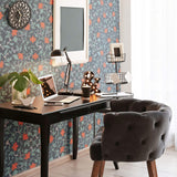 Overlaying a muted foliage pattern with bright red flowers removable wallpaper