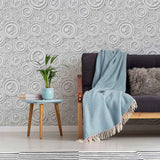 Finding intricacy in the simplest of shapes, this lovely geometric peel and stick wallpaper uses circles of different sizes to create a rich, almost oceanic feel. Rendered mostly in white, this distinctive design makes use of shadows printed in grey to create a raised, 3D effect that further enhances its tactile richness.&nbsp;This PVC-free wallpaper is the perfect add-on to a white-toned setting where the only thing missing is some visual texture.&nbsp;
