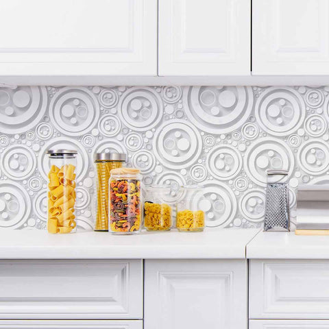 Finding intricacy in the simplest of shapes, this lovely geometric peel and stick wallpaper uses circles of different sizes to create a rich, almost oceanic feel. Rendered mostly in white, this distinctive design makes use of shadows printed in grey to create a raised, 3D effect that further enhances its tactile richness.&nbsp;This PVC-free wallpaper is the perfect add-on to a white-toned setting where the only thing missing is some visual texture.&nbsp;