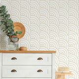 Presenting dreamy, fluffy clouds in a geometric avatar, this minimal yet cheerful geometric wallpaper arranges concentric curvilinear elements in a seamless grid. This black and white removable wallpaper brings both structure and softness to a setting, and is versatile enough for use in spaces ranging from entryways and bedrooms to kitchens and bathrooms.