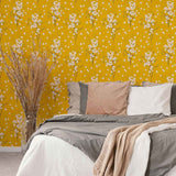 Transform any space into an autumnal paradise with this stunning floral wallpaper that combines gentle white blossoms with an intense mustard yellow background. The small-scale botanical illustrations in this design are simple and almost motif-like, balancing the dramatic yellow hue with a mild whimsical vibe.&nbsp;Try this PVC-free wallpaper to completely transform your bathrooms and utility spaces.