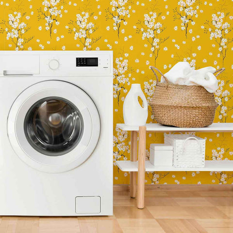 Transform any space into an autumnal paradise with this stunning floral wallpaper that combines gentle white blossoms with an intense mustard yellow background. The small-scale botanical illustrations in this design are simple and almost motif-like, balancing the dramatic yellow hue with a mild whimsical vibe.&nbsp;Try this PVC-free wallpaper to completely transform your bathrooms and utility spaces.