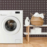 Abstracting a&nbsp;lacy pattern&nbsp;into a network of straight lines, this geometric peel and stick wallpaper finds the sweet spot between organic and structured. Its deep purple background gives it a rooted, regal vibe, on which the white illustrations appear as a stylish contrast. This PVC-free wall covering has a versatile, scalable look that can stylize both expansive rooms and compact surfaces.