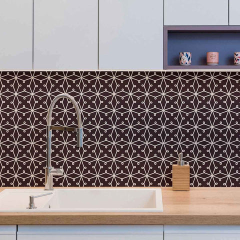 Abstracting a&nbsp;lacy pattern&nbsp;into a network of straight lines, this geometric peel and stick wallpaper finds the sweet spot between organic and structured. Its deep purple background gives it a rooted, regal vibe, on which the white illustrations appear as a stylish contrast. This PVC-free wall covering has a versatile, scalable look that can stylize both expansive rooms and compact surfaces.