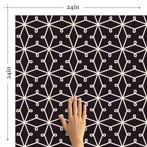 Abstracting a&nbsp;lacy pattern&nbsp;into a network of straight lines, this geometric peel and stick wallpaper finds the sweet spot between organic and structured. Its deep purple background gives it a rooted, regal vibe, on which the white illustrations appear as a stylish contrast. This PVC-free wall covering has a versatile, scalable look that can stylize both expansive rooms and compact surfaces.
