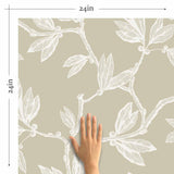 Serving subtle sophistication in serene grey tones, this botanical peel and stick wallpaper turns your walls into a work of art. Branches and leaves meander across the wallpaper panels as white sketches on a warm taupe background. They create a composition that is organic and free, yet structured into a basic geometrical pattern.