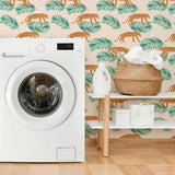 Energize your living space with a gorgeous peel and stick wallpaper featuring leopards and leaves as small-scale illustrations on a pale pink background. This warm and vibrant wallpaper brightens up its surroundings with its intense orange notes and balancing green highlights. Complement this richly finished PVC-free wallpaper with indoor greenery, natural finishes and neutral toned fixtures for a delightful, earthy feel.