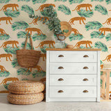 Energize your living space with a gorgeous peel and stick wallpaper featuring leopards and leaves as small-scale illustrations on a pale pink background. This warm and vibrant wallpaper brightens up its surroundings with its intense orange notes and balancing green highlights. Complement this richly finished PVC-free wallpaper with indoor greenery, natural finishes and neutral toned fixtures for a delightful, earthy feel.
