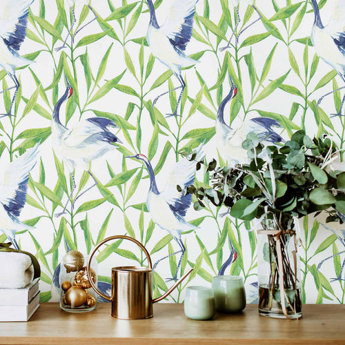 Elegant Japanese cranes flock amid lush green leaves in this vibrant peel and stick wallpaper
