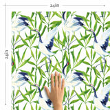 Elegant Japanese cranes flock amid lush green leaves in this vibrant peel and stick wallpaper