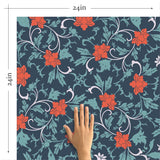 Overlaying a muted foliage pattern with bright red flowers removable wallpaper